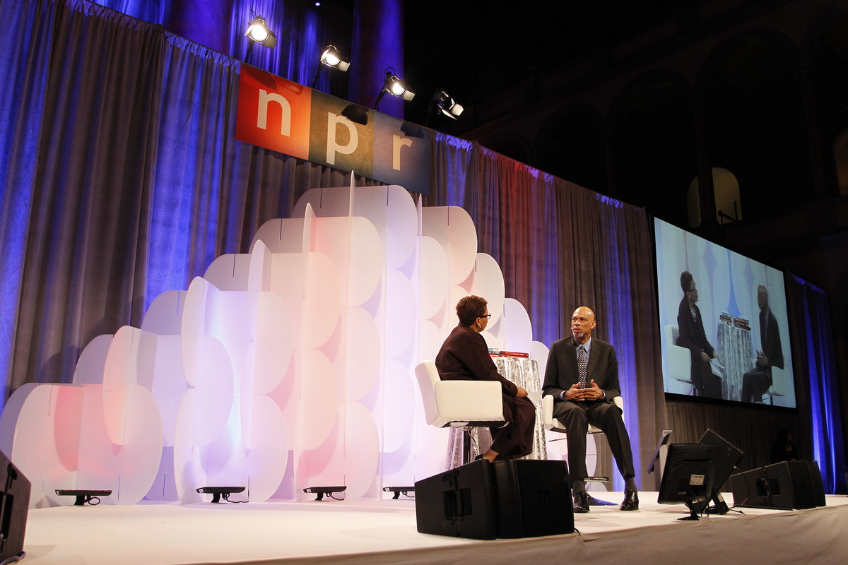 Michel Martin, left, weekend host of NPR's All Things Considered, interviews NBA legend Kareem Abdul-Jabbar at the National Building Museum as part of NPR's annual Weekend in Washington on Friday, October 30, 2015 in Washington, DC. (Paul Morigi/AP Images for NPR)